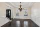 Formal dining room with hardwood floors, chandelier, and wainscoting at 2725 Castel Ln, Cumming, GA 30040