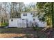 Backyard of a white brick house with a well-maintained lawn and partial fence at 5823 Button Gwinnett Pl, Norcross, GA 30093