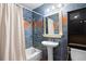 Full bathroom with blue tile, vanity, and shower-tub combination at 5823 Button Gwinnett Pl, Norcross, GA 30093