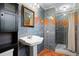 Bathroom with pedestal sink, shower, and decorative tile at 5823 Button Gwinnett Pl, Norcross, GA 30093