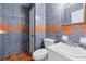 Bathroom with blue and orange tile and pedestal sink at 5823 Button Gwinnett Pl, Norcross, GA 30093