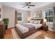 Main bedroom with hardwood floors and neutral decor at 5823 Button Gwinnett Pl, Norcross, GA 30093