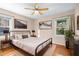 Cozy bedroom featuring hardwood floors, natural light, and a comfortable bed at 5823 Button Gwinnett Pl, Norcross, GA 30093