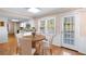 Charming dining area with a round table set near a window and door at 5823 Button Gwinnett Pl, Norcross, GA 30093