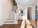 Entryway with hardwood floors and staircase at 5823 Button Gwinnett Pl, Norcross, GA 30093