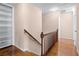 Light-filled upper hallway with hardwood floors and access to rooms at 5823 Button Gwinnett Pl, Norcross, GA 30093