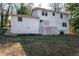 Back of house, white brick, deck, and sloping yard at 5823 Button Gwinnett Pl, Norcross, GA 30093