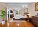 Spacious main bedroom featuring a large bed, modern decor, and hardwood floors at 5823 Button Gwinnett Pl, Norcross, GA 30093