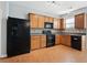 Modern kitchen featuring wood cabinets and black appliances at 216 Parc View Ln, Woodstock, GA 30188