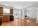 Kitchen boasts wood cabinets, black appliances, and wood flooring at 216 Parc View Ln, Woodstock, GA 30188