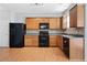 Modern kitchen with wood cabinets and black appliances at 216 Parc View Ln, Woodstock, GA 30188