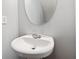 Clean powder room with a white pedestal sink and oval mirror at 216 Parc View Ln, Woodstock, GA 30188