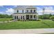 Two-story brick home with a front porch and landscaped lawn at 428 Dahlia St, Mcdonough, GA 30253