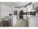 Modern kitchen with white cabinets, island, and breakfast bar at 428 Dahlia St, Mcdonough, GA 30253