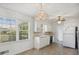 Bright kitchen featuring white cabinetry and a chandelier at 6289 Woodlake Dr, Buford, GA 30518