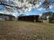 View of the backyard showcasing the home's brick exterior and a glimpse of the surrounding neighborhood at 1261 Cliffwood Se Dr, Smyrna, GA 30080