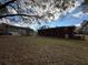 View of the backyard showcasing the home's brick exterior and a glimpse of the surrounding neighborhood at 1261 Cliffwood Se Dr, Smyrna, GA 30080