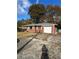 Brick ranch house with attached garage and a gravel driveway at 1261 Cliffwood Se Dr, Smyrna, GA 30080