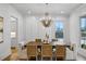 Elegant dining room with a decorative chandelier, wood table, and stylish seating at 165 Grayton Ln, Roswell, GA 30075