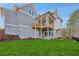 View of the exterior featuring a covered patio, deck, and a spacious backyard, perfect for outdoor living and entertaining at 165 Grayton Ln, Roswell, GA 30075