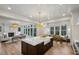 Spacious kitchen with a center island, farmhouse sink, open to a living room with fireplace and dining area at 165 Grayton Ln, Roswell, GA 30075