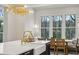 Kitchen island featuring white countertops, brass fixtures, and view to dining area at 165 Grayton Ln, Roswell, GA 30075