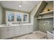 Well-lit laundry room with marble-like tile, shaker cabinets, a sink, countertop space, open shelves and three large windows at 165 Grayton Ln, Roswell, GA 30075