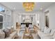 Open-concept living room showcasing elegant light fixture and seamless flow to the adjacent kitchen area at 165 Grayton Ln, Roswell, GA 30075