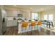 Open-concept kitchen and dining area, showcasing the island with seating, stainless steel appliances, and seamless flow to the dining table at 2456 Bayberry St, Acworth, GA 30101