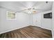 Bright bedroom featuring wood-look floors and ceiling fan at 4805 Blossom Ct, Cumming, GA 30028