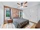 Bright bedroom with wood floors, large windows, and ceiling fan at 4805 Blossom Ct, Cumming, GA 30028