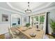 Formal dining room with hardwood floors, large windows, and a chandelier at 4805 Blossom Ct, Cumming, GA 30028