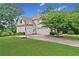 Two-story house with a three-car garage, basketball court, and lush lawn at 4805 Blossom Ct, Cumming, GA 30028