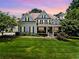 Two-story house with a gray exterior, white trim, and a lush lawn at 4805 Blossom Ct, Cumming, GA 30028