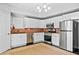 Modern kitchen with white cabinets and stainless steel appliances at 4805 Blossom Ct, Cumming, GA 30028