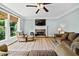 Bright living room featuring a stone fireplace and hardwood floors at 4805 Blossom Ct, Cumming, GA 30028