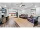 Open living room with brown leather furniture and kitchen view at 4805 Blossom Ct, Cumming, GA 30028