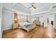 Main bedroom with hardwood floors and tray ceiling at 4805 Blossom Ct, Cumming, GA 30028