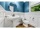 Powder room with a pedestal sink, blue walls, and white wainscoting at 4805 Blossom Ct, Cumming, GA 30028