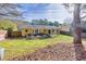 Landscaped backyard with a yellow house and large tree at 1237 Torrey Pl, Dacula, GA 30019