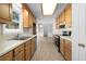 Galley style kitchen with light wood cabinets and stainless steel appliances at 1237 Torrey Pl, Dacula, GA 30019