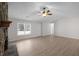 Living room with a stone fireplace and wood-look laminate floors at 1237 Torrey Pl, Dacula, GA 30019