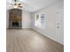 Bright living room featuring a stone fireplace and laminate wood floors at 1237 Torrey Pl, Dacula, GA 30019