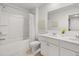 Bright bathroom with dual sinks, white cabinets, and a shower-tub combination at 2476 Bayberry St, Acworth, GA 30101