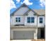 Charming two-story home with white siding, a brick facade, gray accents, and a two-car garage at 2476 Bayberry St, Acworth, GA 30101