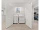 White laundry room features a washer and dryer behind a set of open double doors at 2476 Bayberry St, Acworth, GA 30101