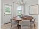 Bright dining room featuring a round wooden table and comfortable seating at 329 Foxglove Way, Mcdonough, GA 30253