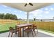 Covered patio with outdoor dining set and backyard view at 329 Foxglove Way, Mcdonough, GA 30253