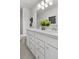 Double vanity bathroom with white cabinets and a large mirror at 336 Foxglove Way, Mcdonough, GA 30253