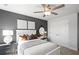 Bedroom with white bed frame and grey accent wall at 336 Foxglove Way, Mcdonough, GA 30253